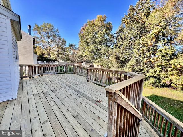 a view of balcony with wooden floor and fence