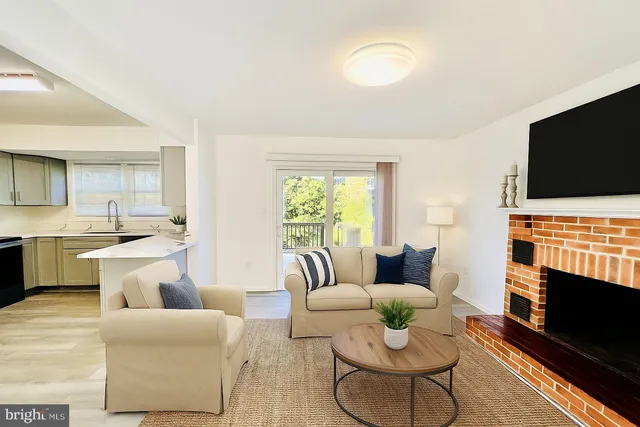 a living room with fireplace furniture and a flat screen tv