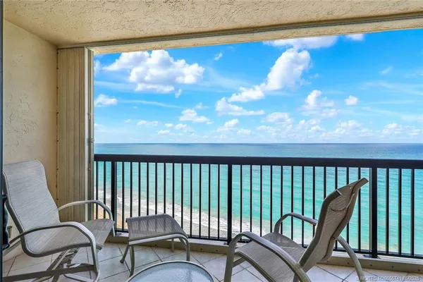 a view of a balcony with chairs