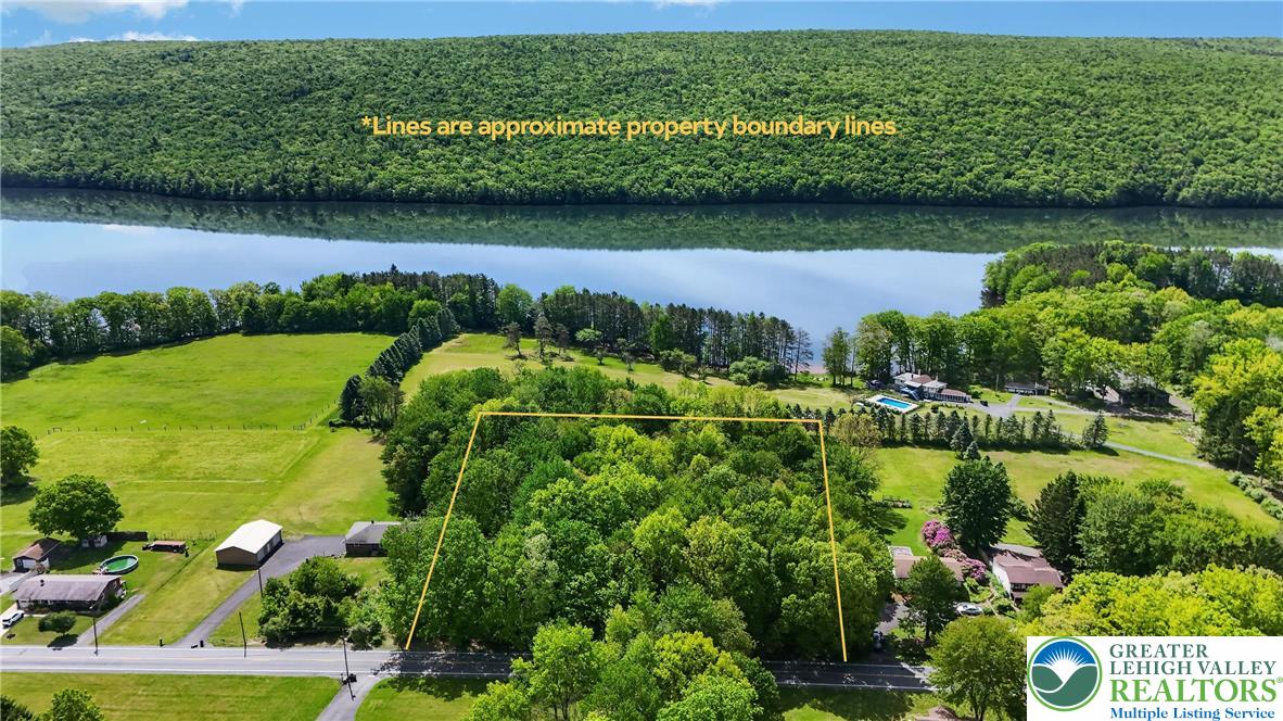 Ben Titus Road Tamaqua, PA 18252 - Photo 1 of 7 Discover a tranquil lakeside retreat with verdant trees and serene waters, perfect for building a dream home.
