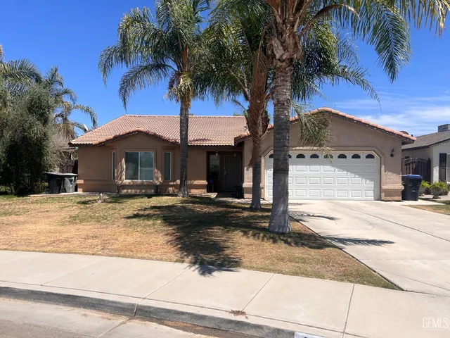 a front view of a house with garden and patio