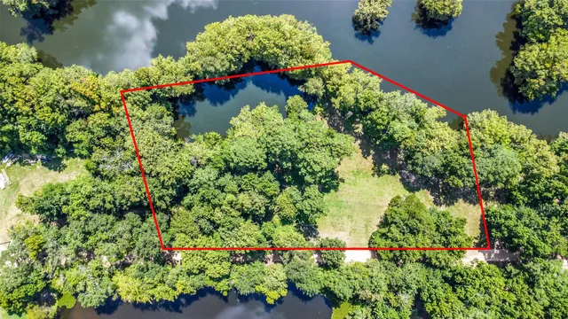 an aerial view of a house with a yard and garden