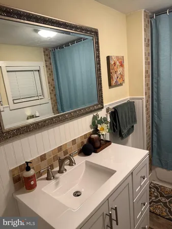 a bathroom with a sink and a mirror