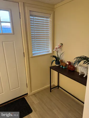 a view of a room with a window and wooden floor