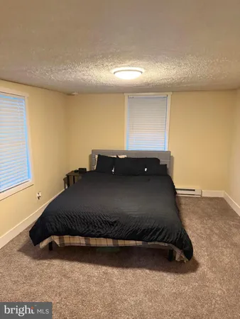 a bed sitting in a room next to a window