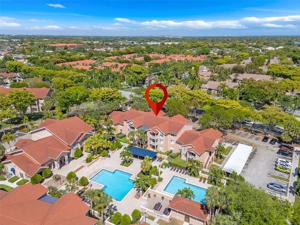 an aerial view of residential houses with outdoor space