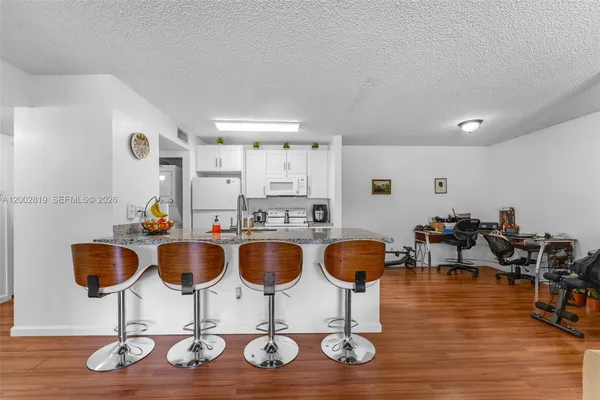 a room with lots of chairs and wooden floor