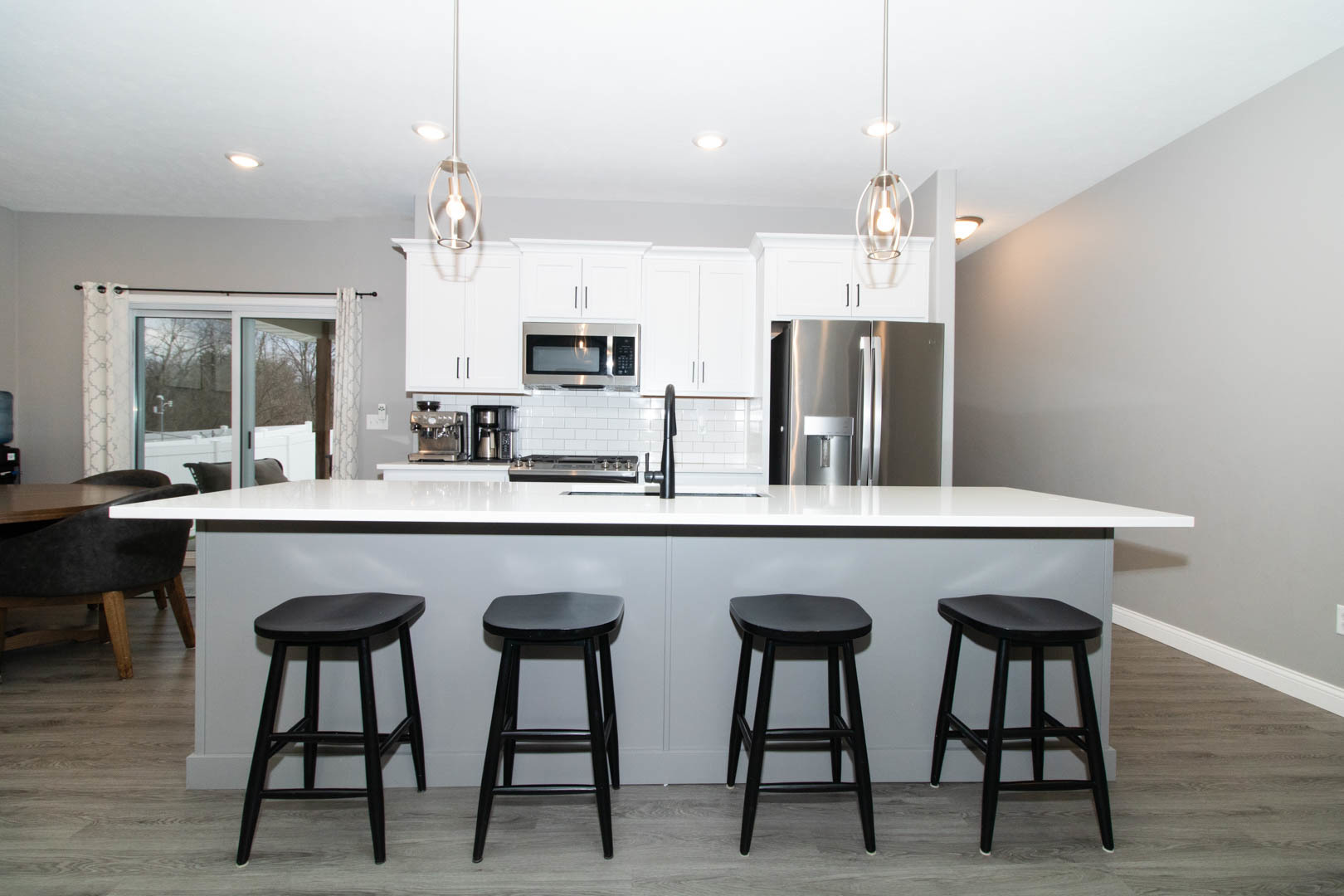 300 Raef Road Downs, IL 61736 - Photo 11 of 47 a kitchen with stainless steel appliances granite countertop a table chairs sink and microwave