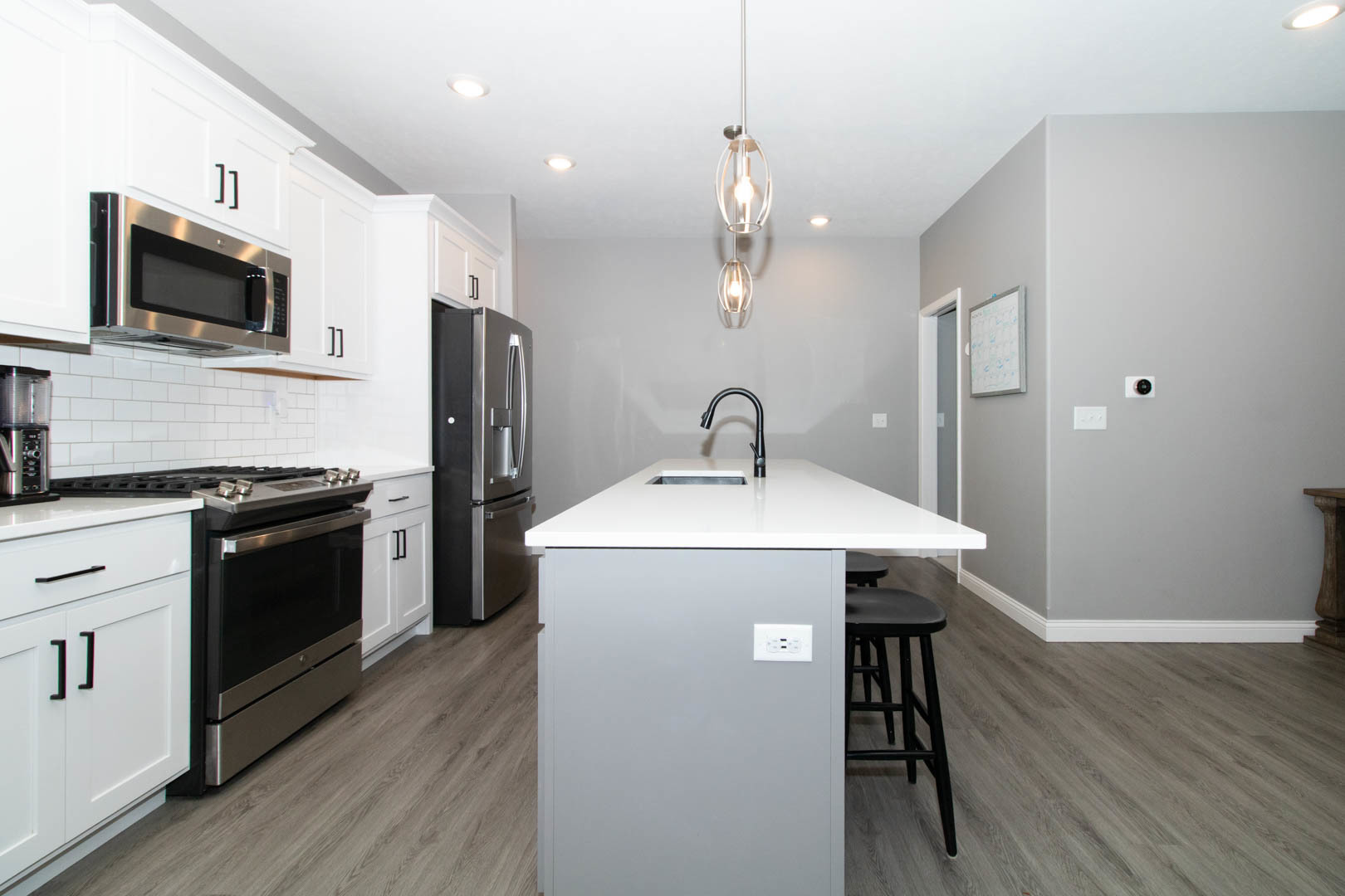 300 Raef Road Downs, IL 61736 - Photo 12 of 47 a kitchen with kitchen island a sink appliances and wooden floor
