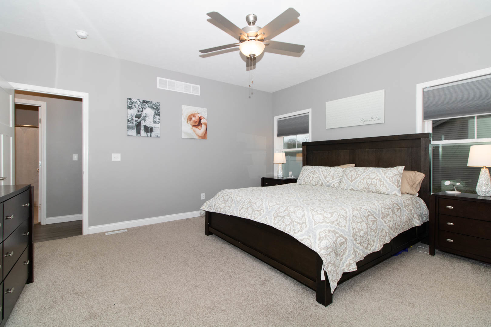 300 Raef Road Downs, IL 61736 - Photo 27 of 47 a spacious bedroom with a bed and a ceiling fan