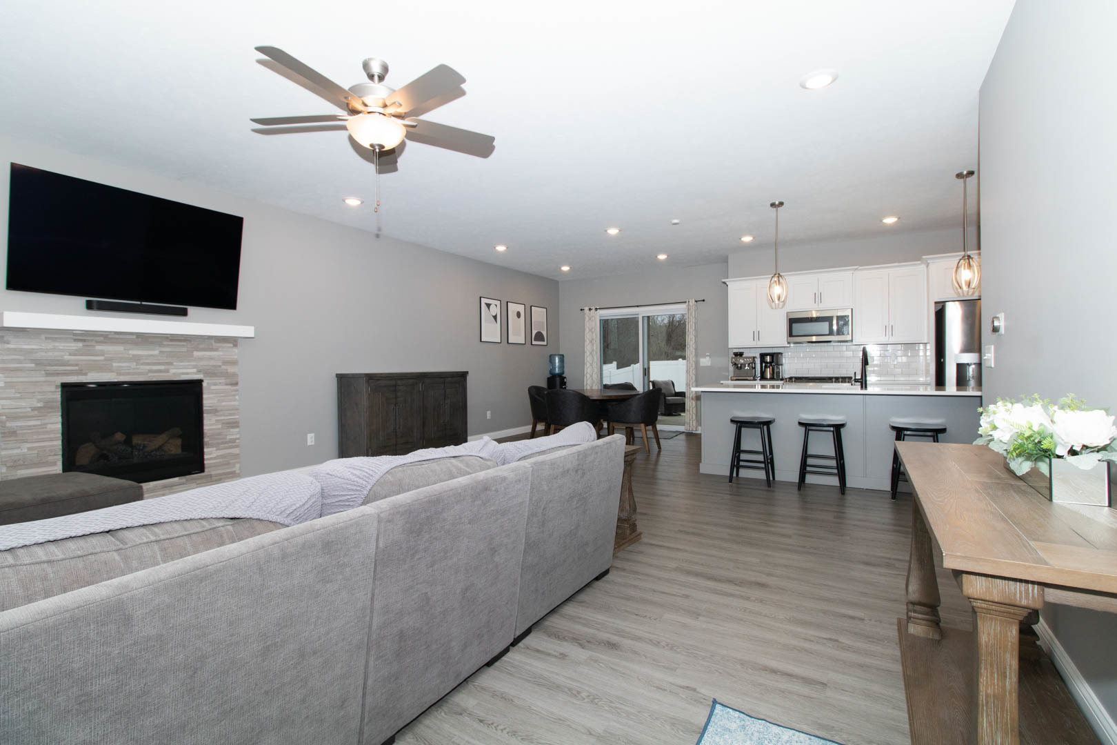 300 Raef Road Downs, IL 61736 - Photo 3 of 47 a living room with furniture a flat screen tv and kitchen view