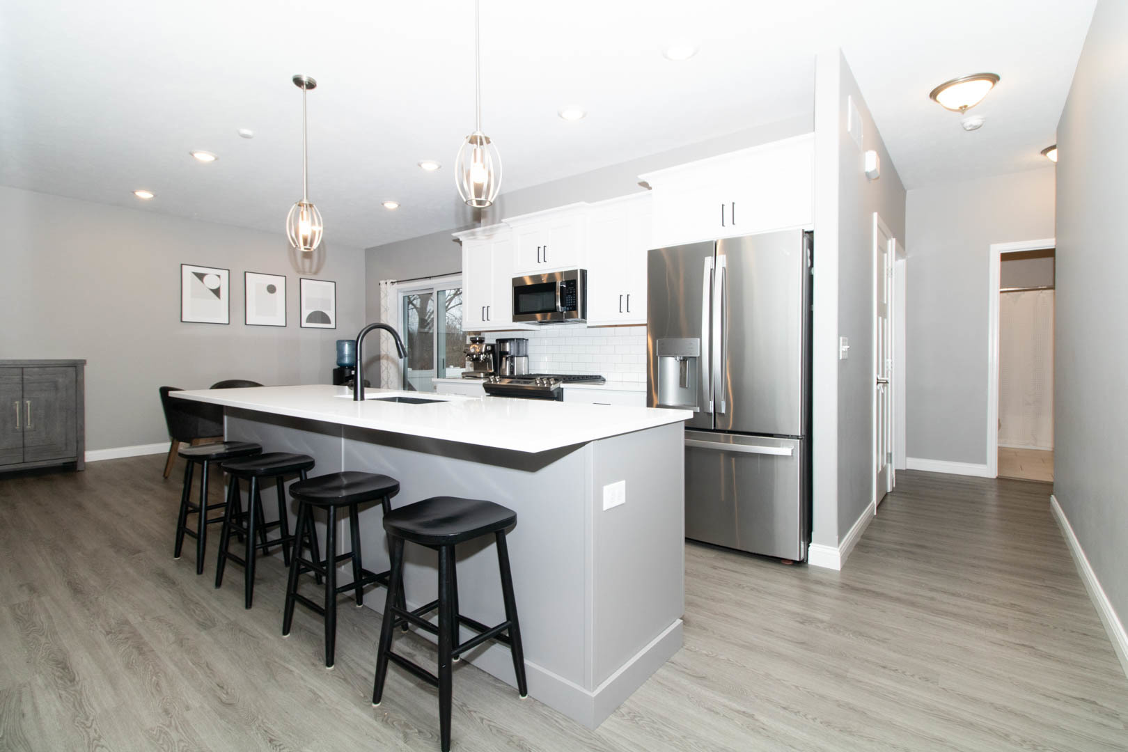 300 Raef Road Downs, IL 61736 - Photo 10 of 47 a kitchen with stainless steel appliances kitchen island a table chairs in it and wooden floors