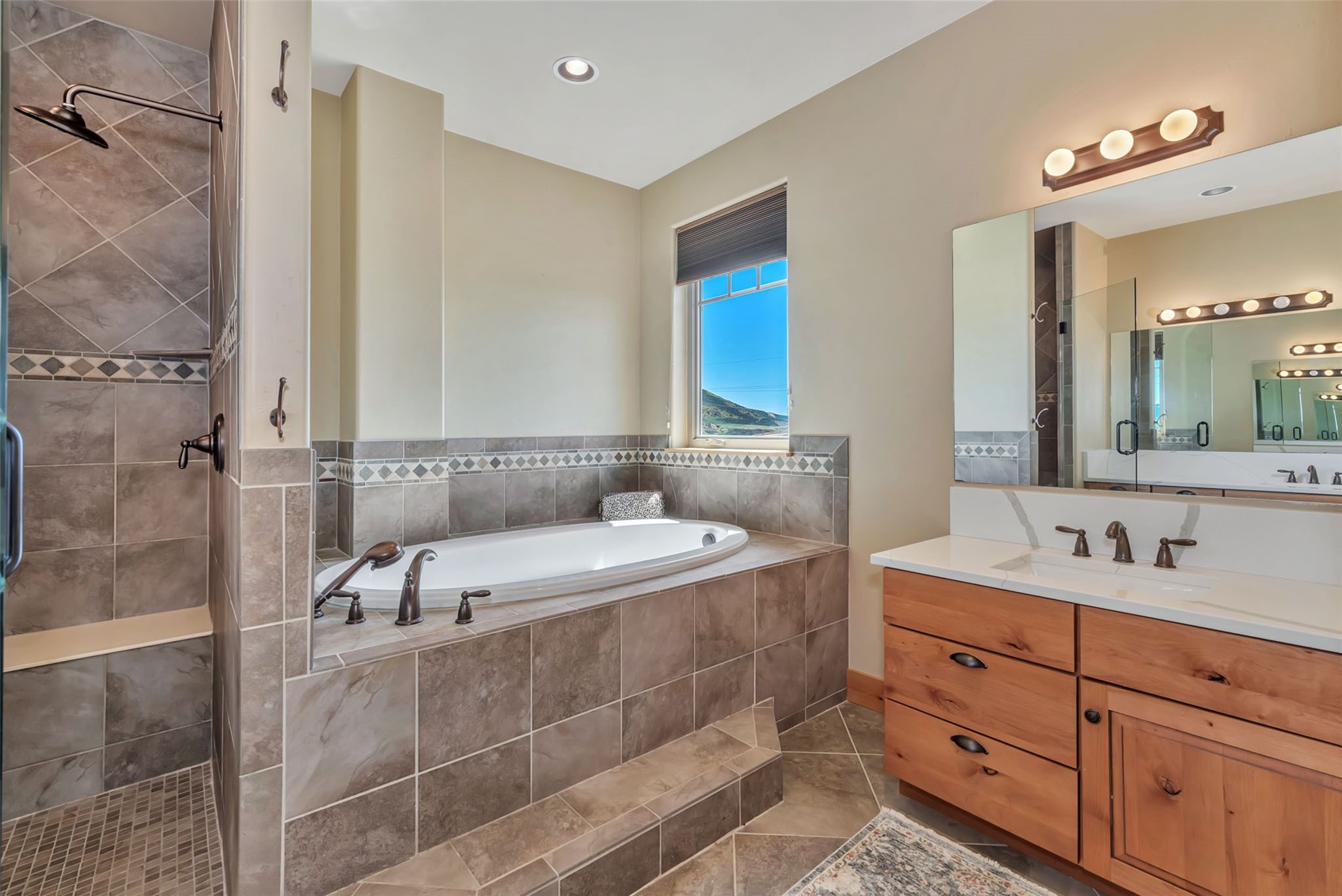 938 South Dry Creek Road Hayden, CO 81639 - Photo 28 of 34 a bathroom with a tub sink and mirror