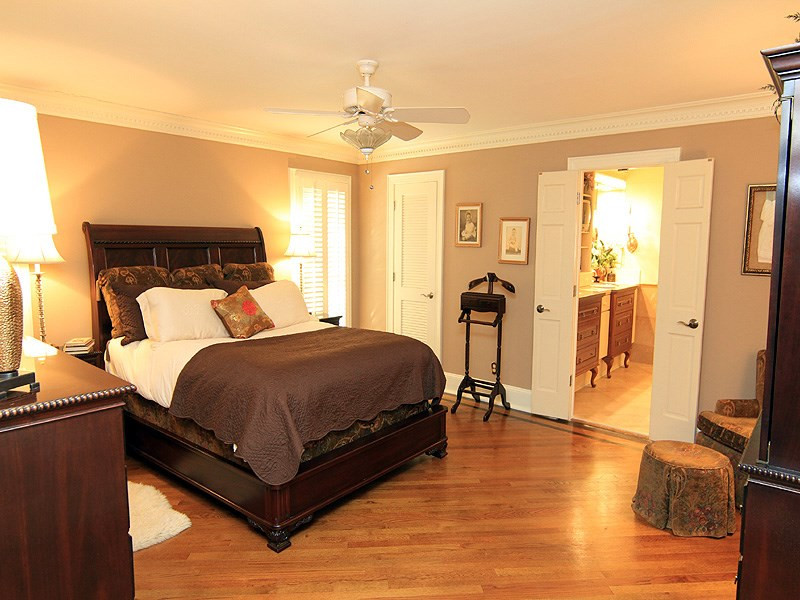 2204 Customs House Court Raleigh, NC 27615 - Photo 16 of 25 The master bedroom is tucked away on the first floor. Hardwood floors, moldings, walk-in closets, ceiling fan. Master Bedroom