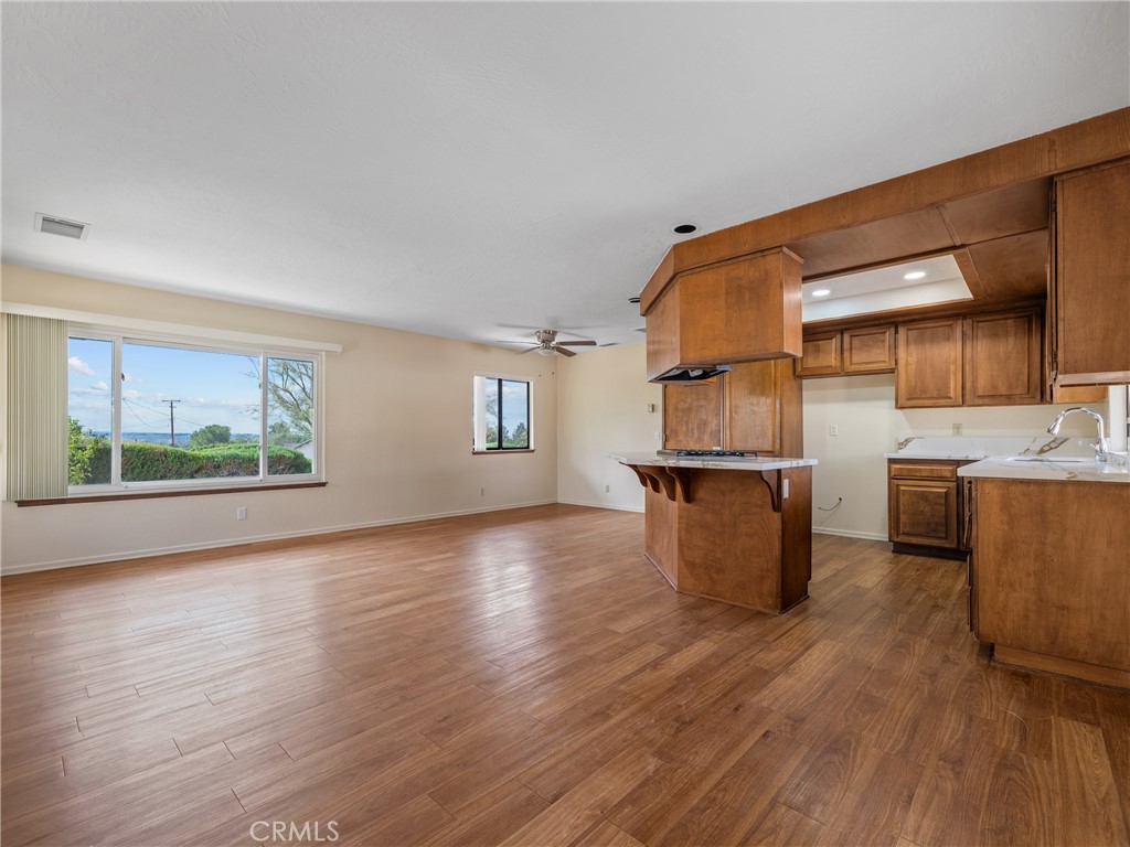 19236 Hupa Road Apple Valley, CA 92307 - Photo 12 of 44 a view of a kitchen with furniture and wooden floor