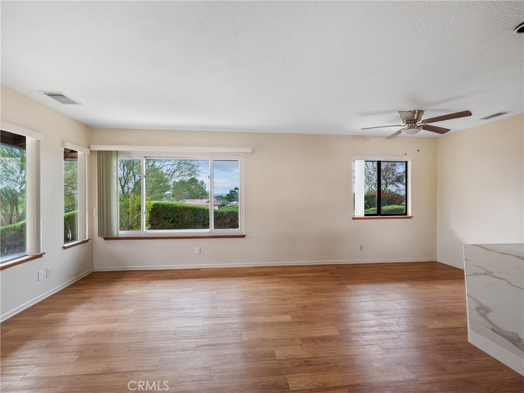 19236 Hupa Road Apple Valley, CA 92307 - Photo 13 of 44 a view of an empty room with a window and wooden floor