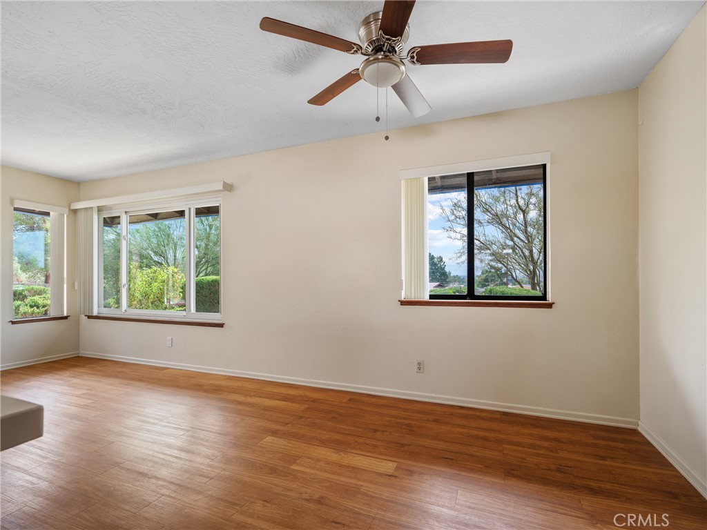 19236 Hupa Road Apple Valley, CA 92307 - Photo 14 of 44 a view of an empty room with wooden floor and a window