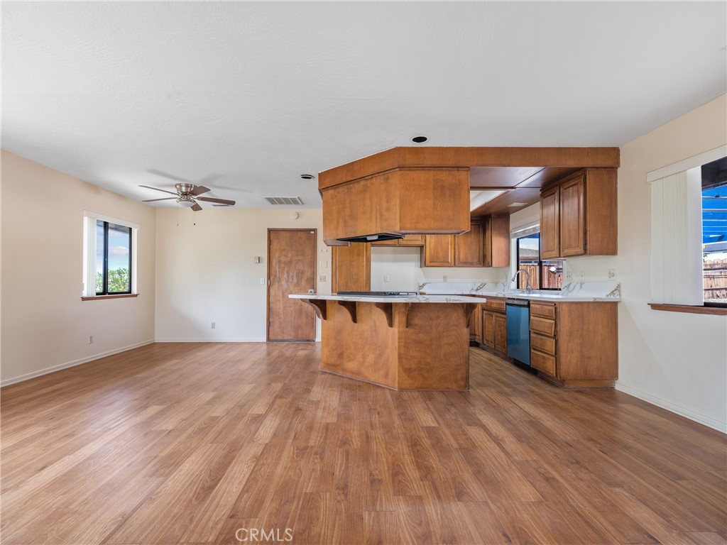 19236 Hupa Road Apple Valley, CA 92307 - Photo 15 of 44 a room with kitchen island granite countertop wooden floors and a sink