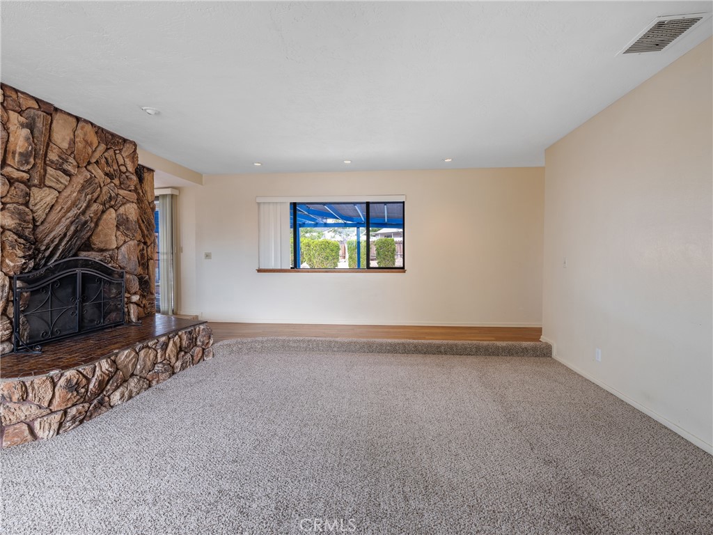 19236 Hupa Road Apple Valley, CA 92307 - Photo 17 of 44 a view of a livingroom with wooden floor and a flat screen tv