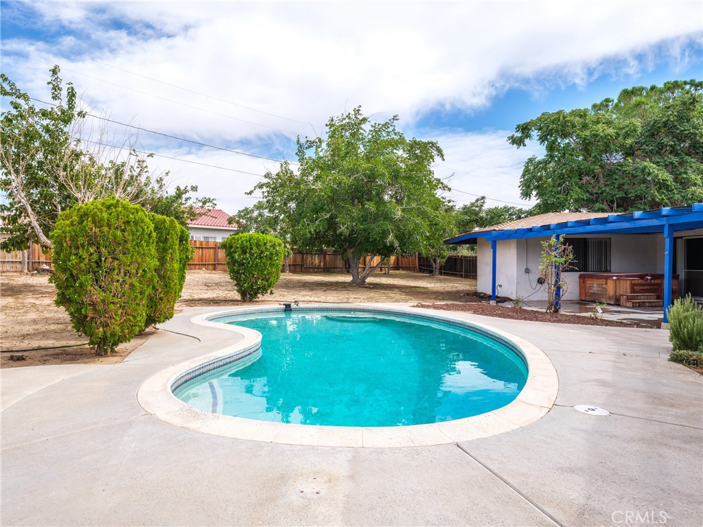 19236 Hupa Road Apple Valley, CA 92307 - Photo 32 of 44 a view of a house with swimming pool and sitting area