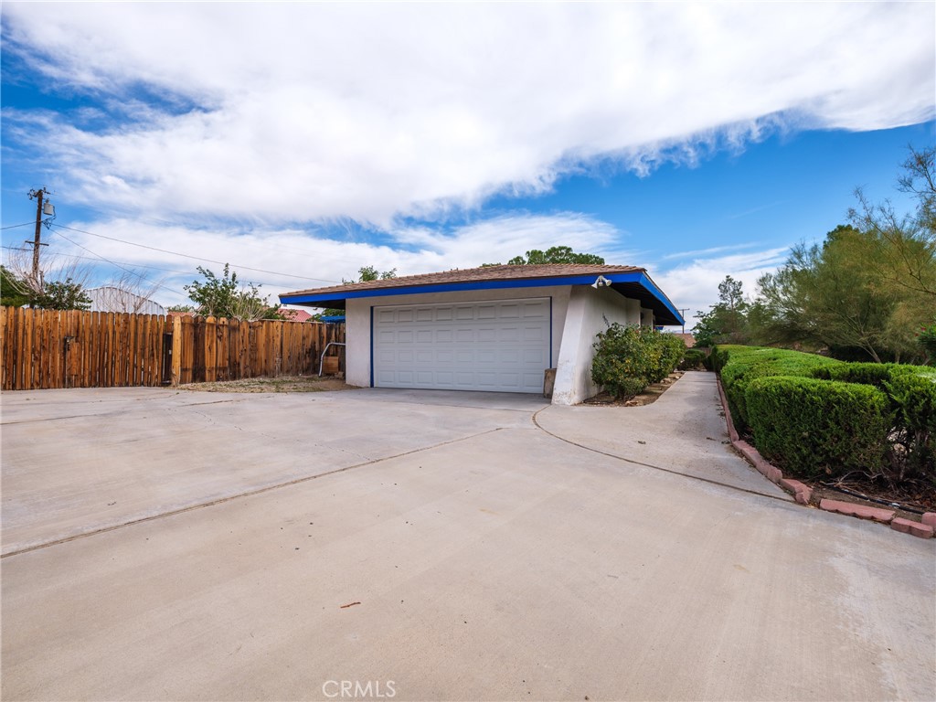 19236 Hupa Road Apple Valley, CA 92307 - Photo 42 of 44 front view of a house with a yard and potted plants