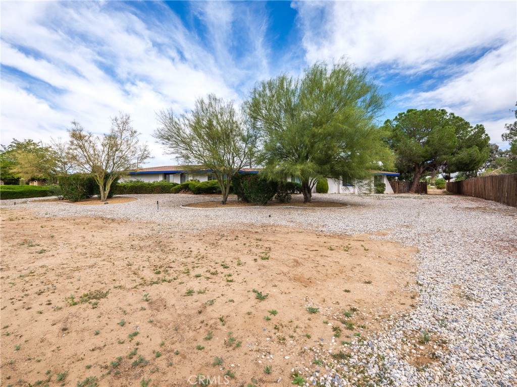 19236 Hupa Road Apple Valley, CA 92307 - Photo 44 of 44 a view of a backyard with large trees