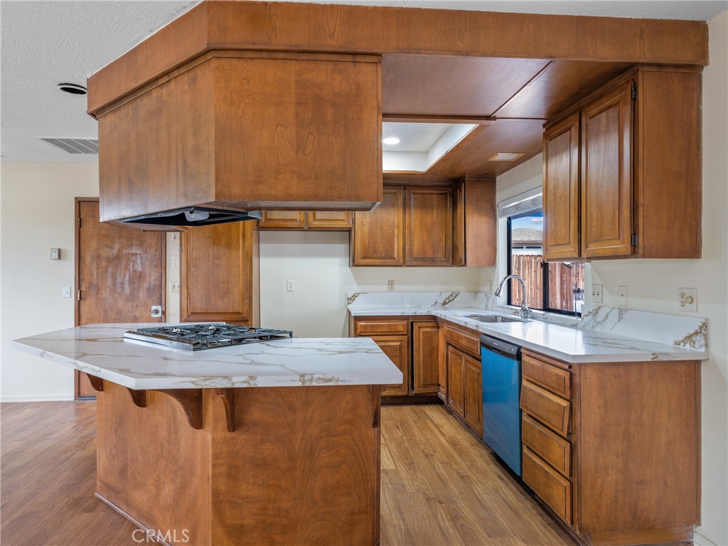 19236 Hupa Road Apple Valley, CA 92307 - Photo 10 of 44 a kitchen with stainless steel appliances granite countertop a sink stove and cabinets