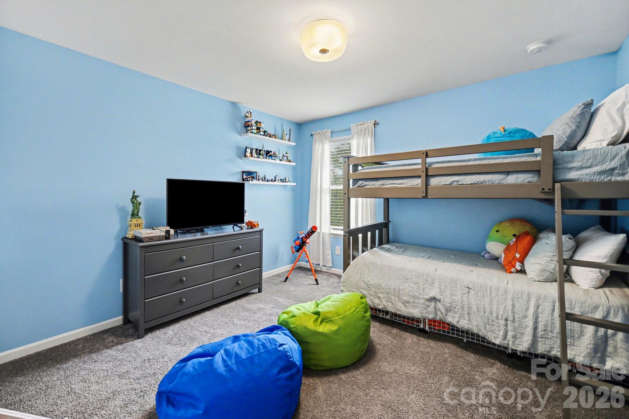 6423 Kinder Lane Lancaster, SC 29720 - Photo 20 of 48 a bedroom with a bed and flat screen tv