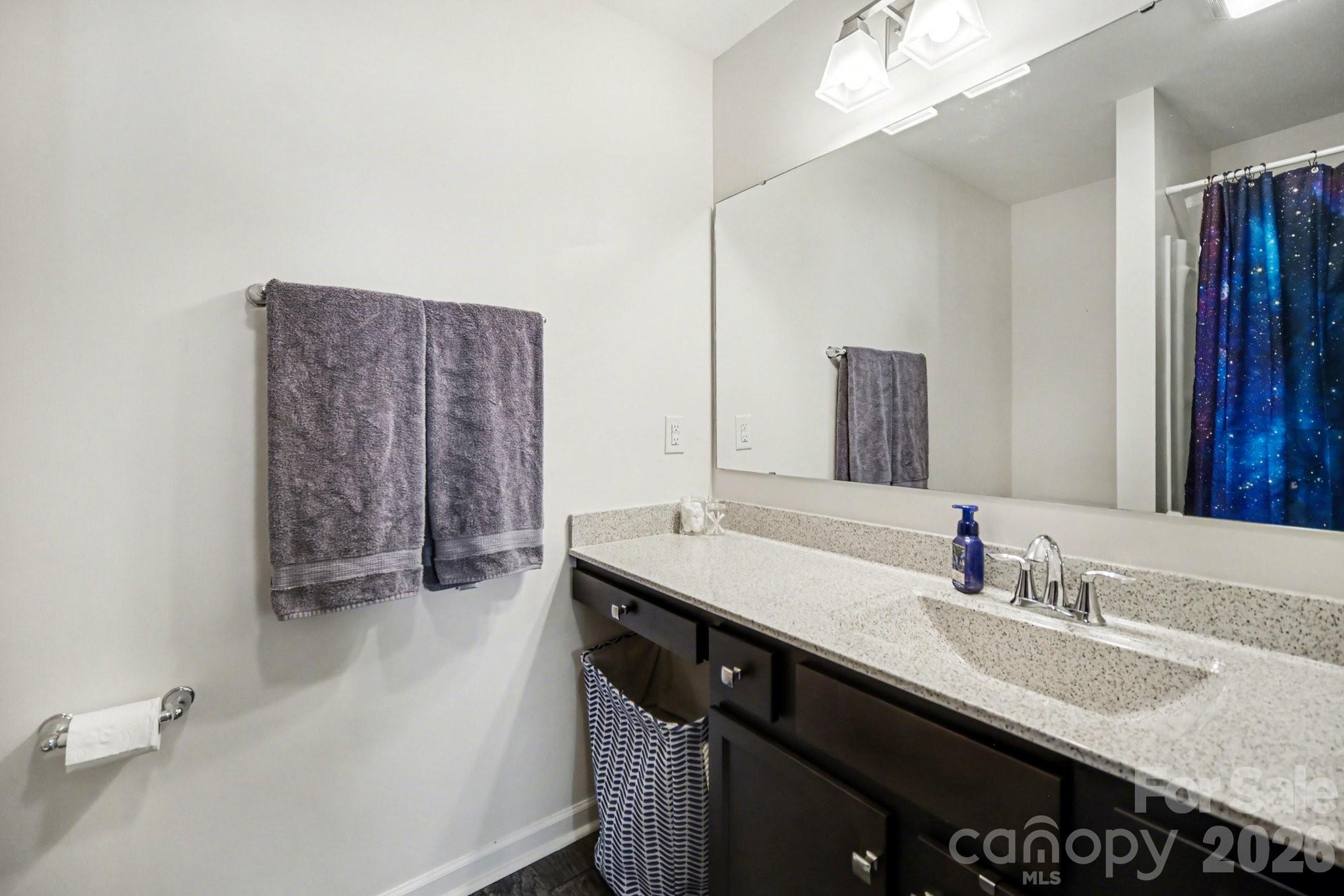 6423 Kinder Lane Lancaster, SC 29720 - Photo 21 of 48 a bathroom with a granite countertop sink a large mirror and a shower