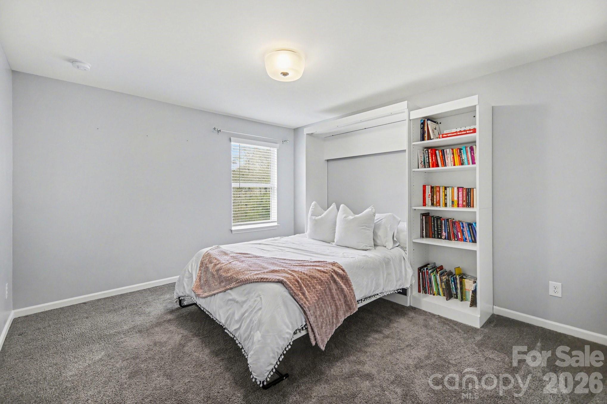 6423 Kinder Lane Lancaster, SC 29720 - Photo 30 of 48 a bedroom with a bed and a book shelf