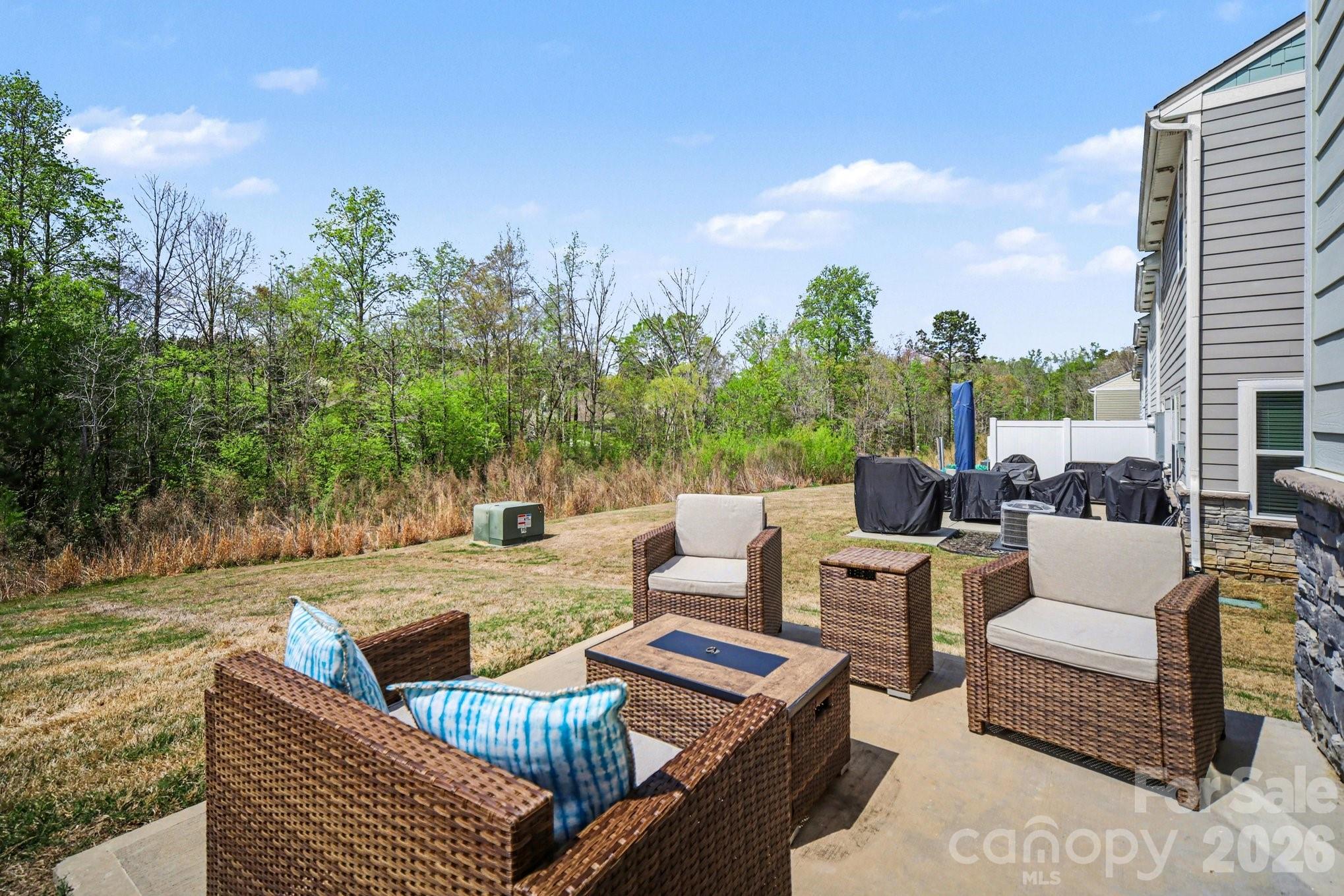 6423 Kinder Lane Lancaster, SC 29720 - Photo 37 of 48 a view of a patio with couches chairs and a potted plant on the table