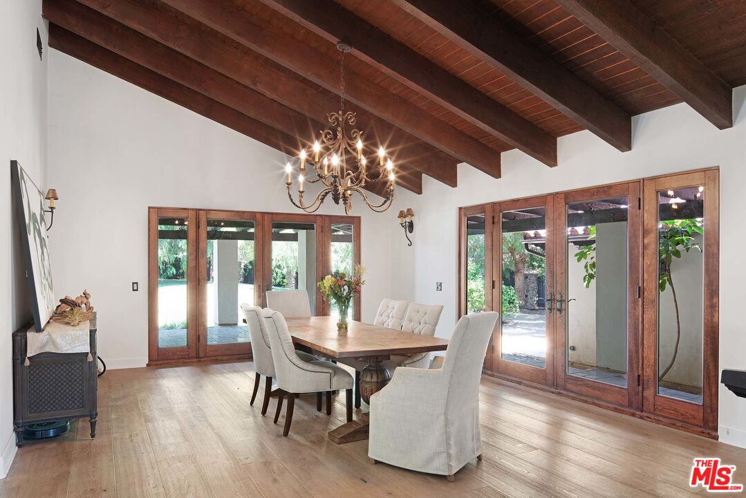 2251 Cold Canyon Road Calabasas, CA 91302 - Photo 15 of 47 a view of a dining room with furniture wooden floor and chandelier
