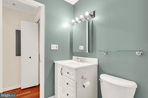 a bathroom with a toilet sink and mirror