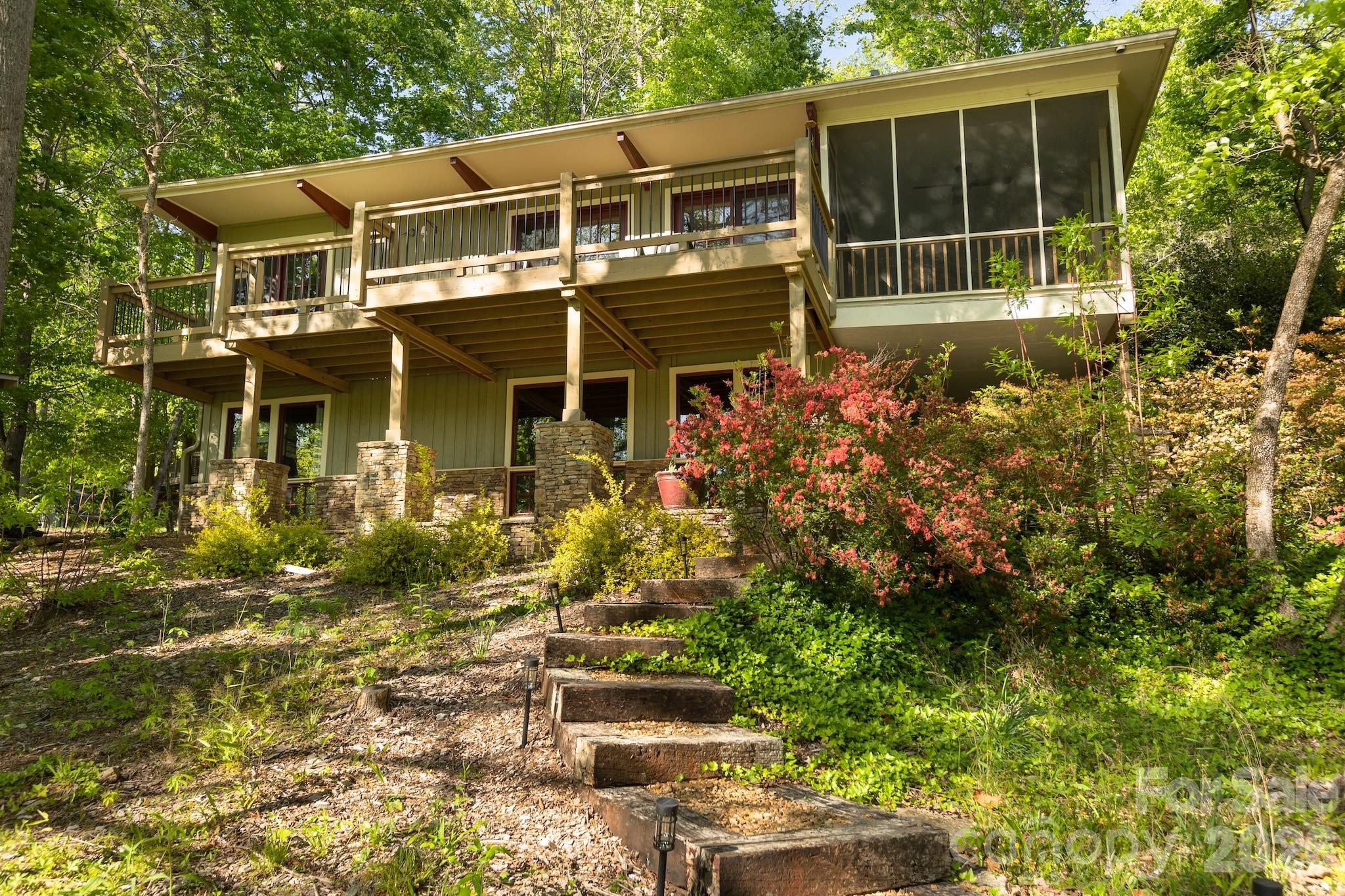 1971 Buffalo Creek Road Lake Lure, NC 28746 - Photo 1 of 31 a front view of a house with a garden