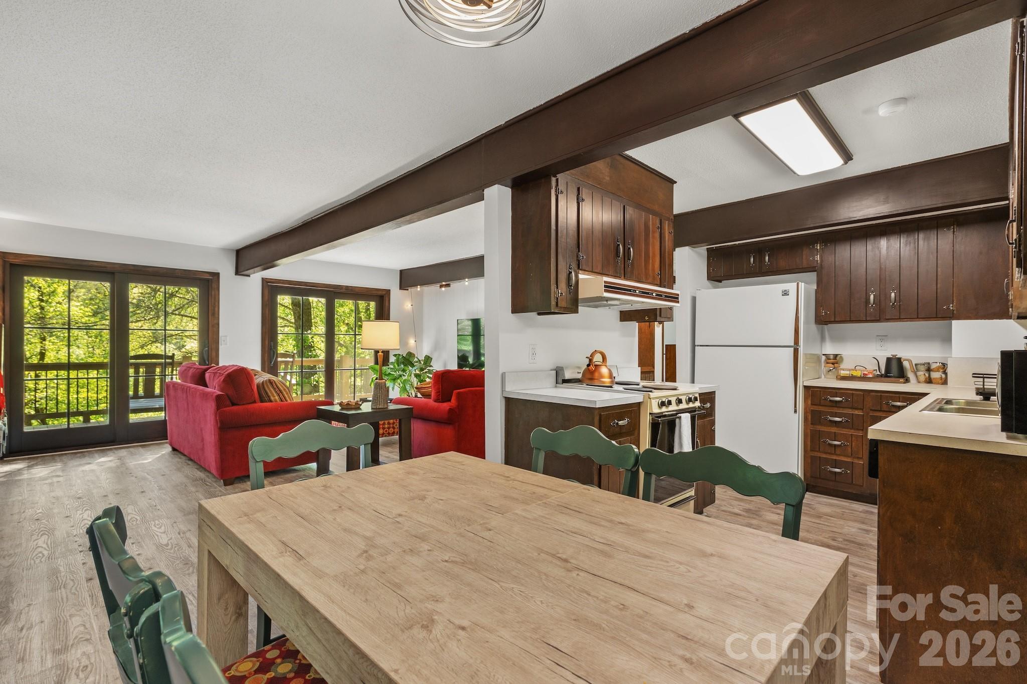 1971 Buffalo Creek Road Lake Lure, NC 28746 - Photo 11 of 31 a kitchen with stainless steel appliances kitchen island granite countertop a refrigerator a stove and a sink dishwasher with wooden floor