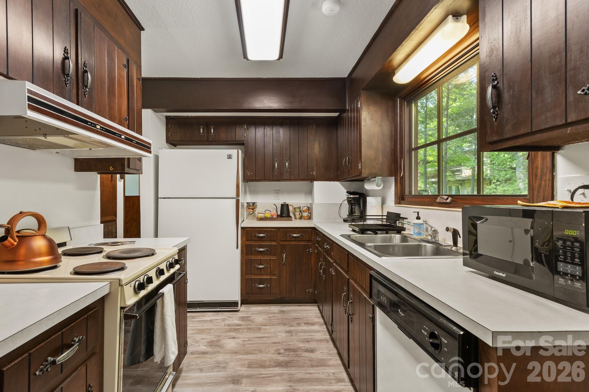 1971 Buffalo Creek Road Lake Lure, NC 28746 - Photo 13 of 31 a kitchen with a stove a sink and a window