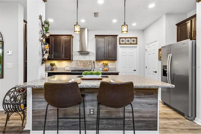 a kitchen with granite countertop stainless steel appliances and cabinets