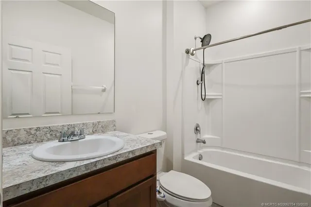 a living room with patio furniture and a floor to ceiling window