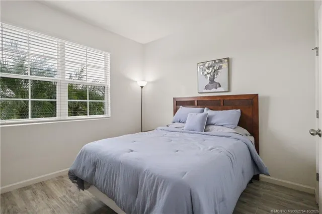 a large bed sitting in a bedroom next to a window