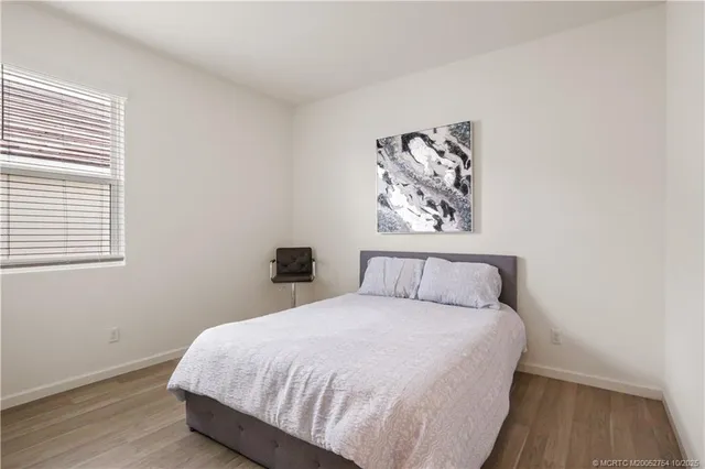 a bedroom with a bed and chair