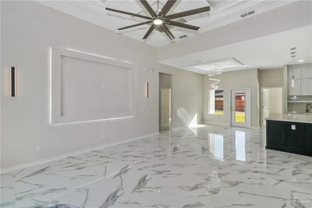 a view of an empty room with window and cabinet