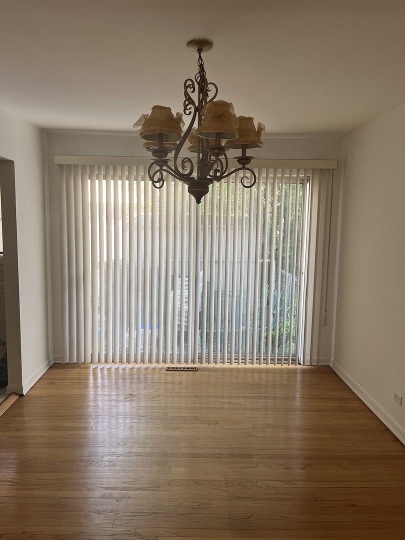 8812 Dee Road Des Plaines, IL 60016 - Photo 3 of 13 a view of wooden floor and a window in a room