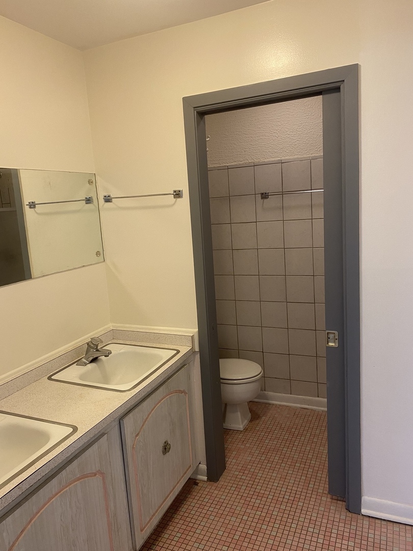 8812 Dee Road Des Plaines, IL 60016 - Photo 6 of 13 a bathroom with a granite countertop sink toilet and shower