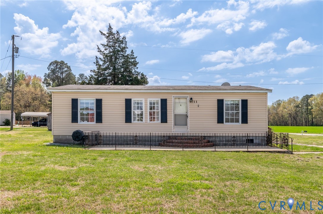 9711 Robin Road Disputanta, VA 23842 - Photo 2 of 29 a view of house with yard outdoor seating and barbeque oven
