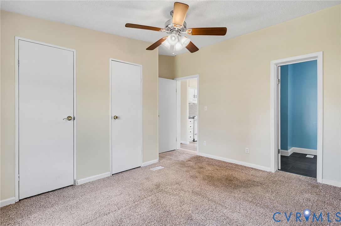 9711 Robin Road Disputanta, VA 23842 - Photo 22 of 29 a view of an empty room with a ceiling fan