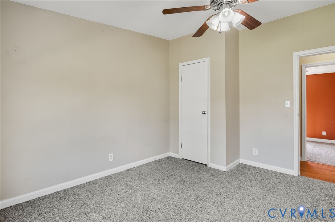 9711 Robin Road Disputanta, VA 23842 - Photo 26 of 29 an empty room with a chandelier fan