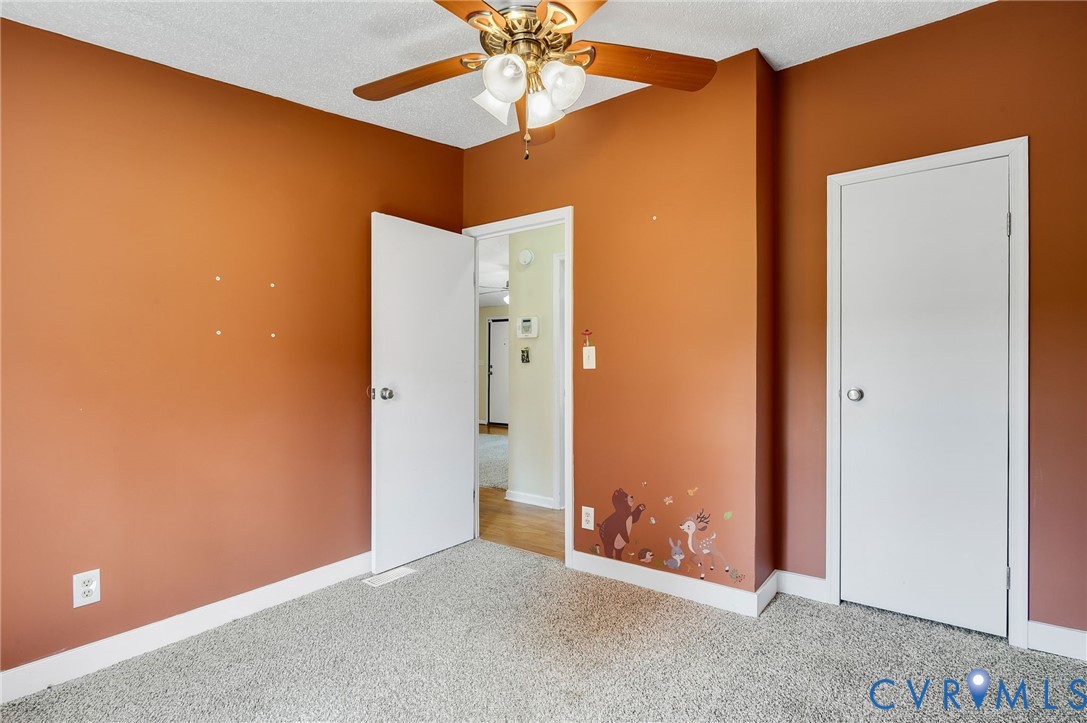 9711 Robin Road Disputanta, VA 23842 - Photo 29 of 29 an empty room with closet and a chandelier fan