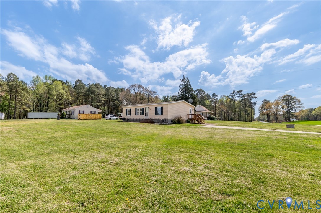 9711 Robin Road Disputanta, VA 23842 - Photo 5 of 29 a front view of house with yard and trees