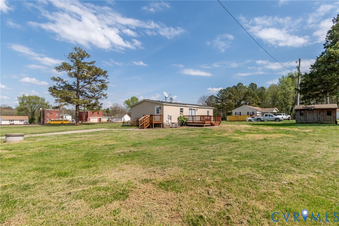 9711 Robin Road Disputanta, VA 23842 - Photo 8 of 29 a front view of a house with a yard table and chairs