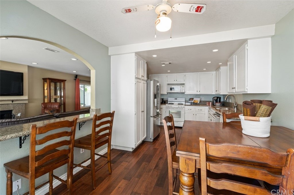 28825 Woodspring Circle Lake Forest, CA 92679 - Photo 16 of 50 a kitchen with a dining table chairs and kitchen view